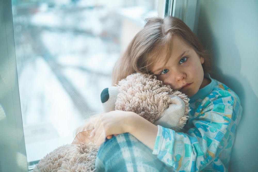 walk-in care | sick child hugging stuffed toy
